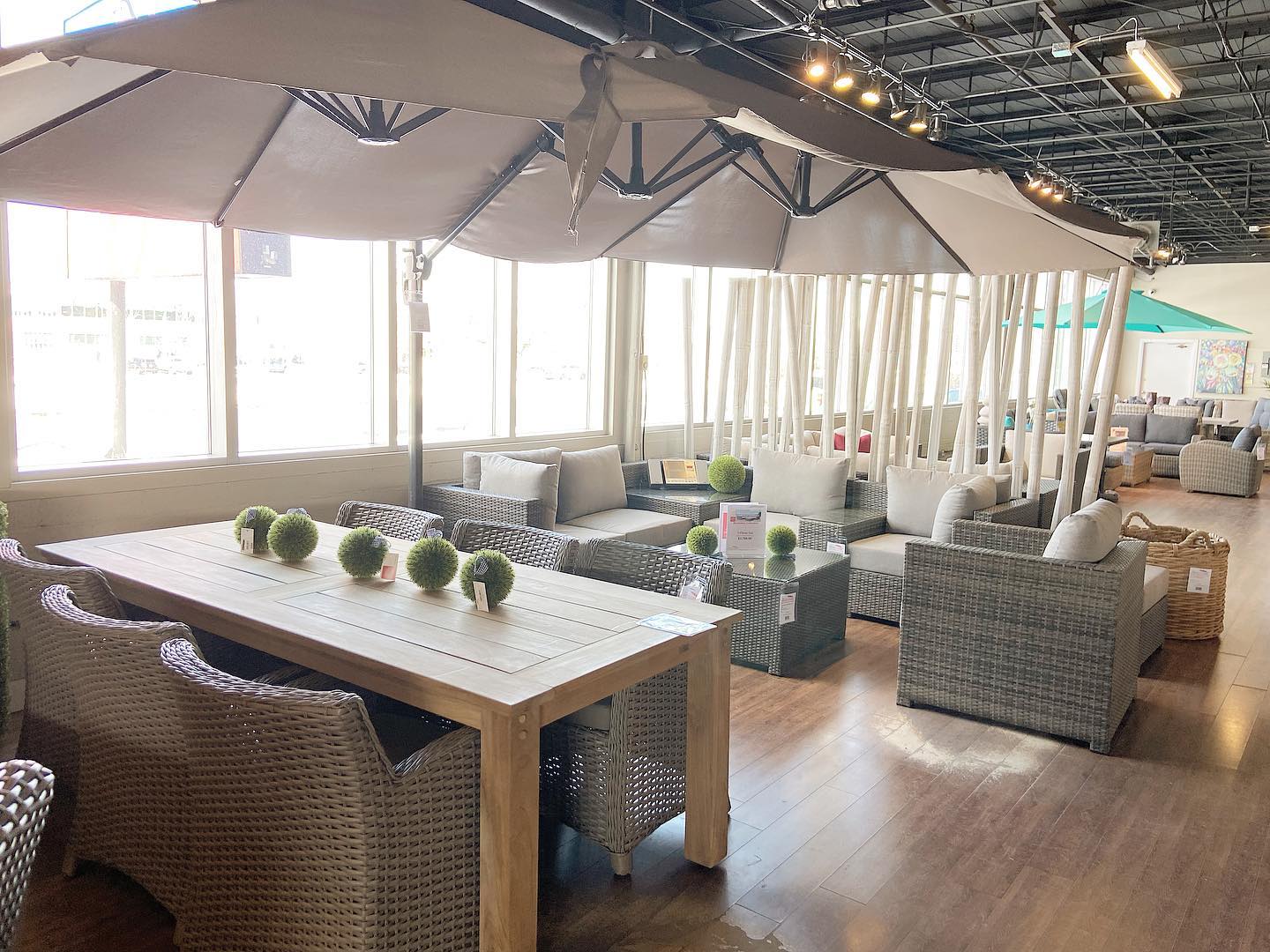 Patio Store showroom with outdoor dining furniture, lounge seating and umbrellas